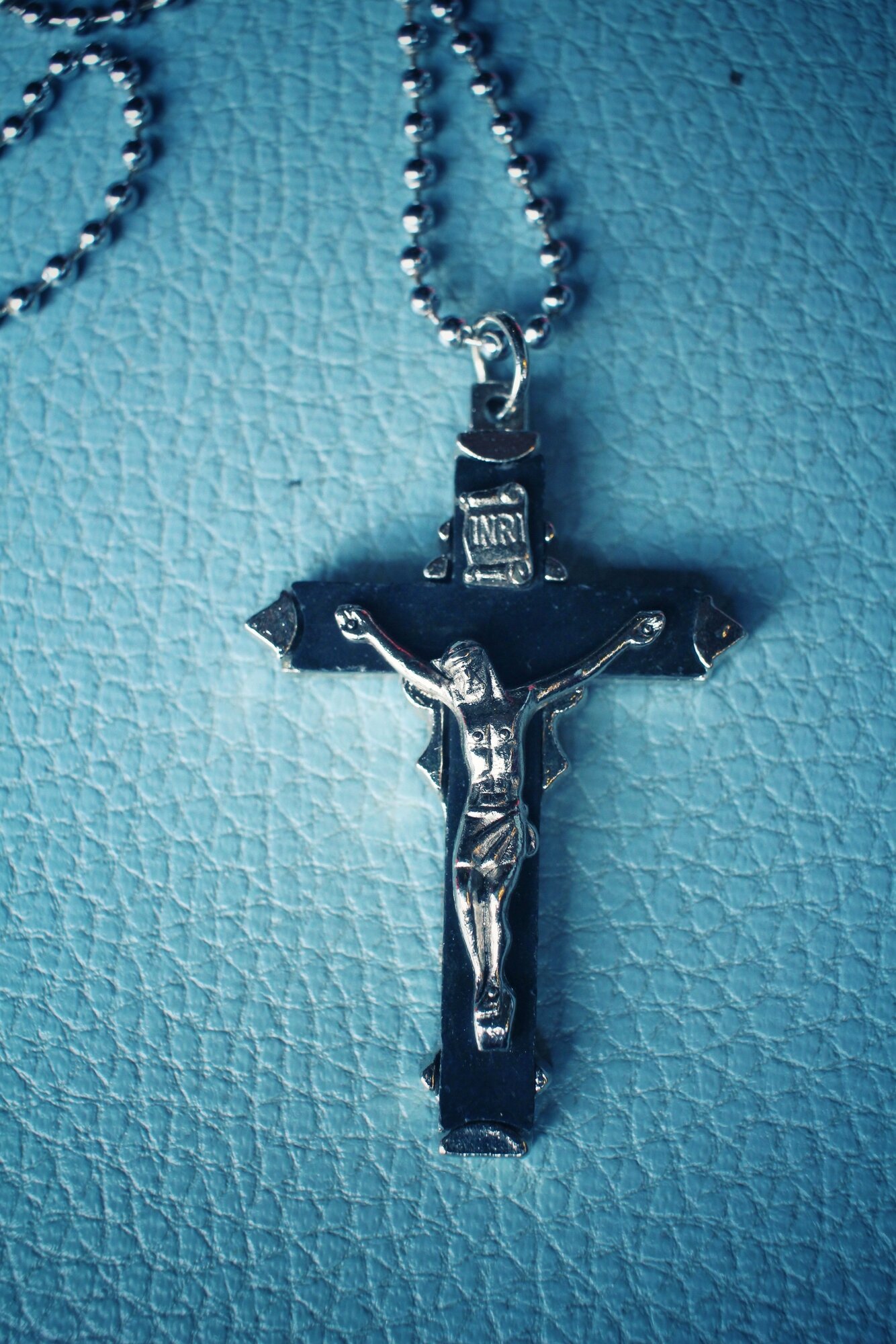 cross-necklace-what-does-it-mean-silver-crucifix-blue-background